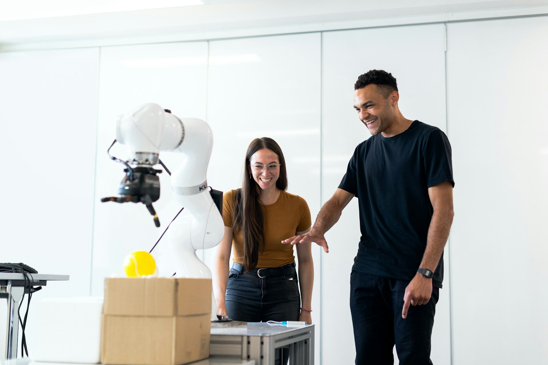 People looking at a robot arm and steer it